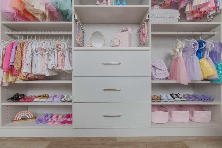 Custom reach-in closet system with ODI cabinetry by Closet Concepts